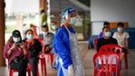 A medical worker wearing protective suits stand beside people waiting for their turn for coronavirus testing at a center for private Covid-19 testing in Petaling Jaya, Malaysia,(AP) A medical worker wearing protective suits stand beside people waiting for their turn for coronavirus testing at a center for private Covid-19 testing in Petaling Jaya, Malaysia,(AP)
