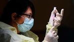 A registered pharmacist technician, carefully fills the Pfizer-BioNTech COVID-19 mRNA vaccine at a clinic.(AP) A registered pharmacist technician, carefully fills the Pfizer-BioNTech COVID-19 mRNA vaccine at a clinic.(AP)
