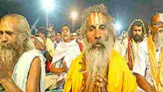 Hindu holy men and devotees offer evening prayers on the banks of the River Ganges in Allahabad on Saturday, May 26, 2007.
