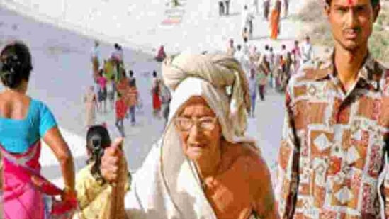 An elderly old woman returns after taking a dip in holy river Ganga on the occasion of Ganga Dussehra in Allahabad on Saturday, May 26, 2007.