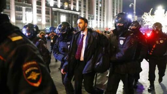 Policemen detain a Navalny supporter near Red Square in Moscow, Russia. (AP) Policemen detain a Navalny supporter near Red Square in Moscow, Russia. (AP)