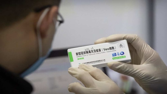 A medical worker shows the box for a coronavirus vaccine to a patient at a vaccination facility in Beijing.(AP Photo) A medical worker shows the box for a coronavirus vaccine to a patient at a vaccination facility in Beijing.(AP Photo)