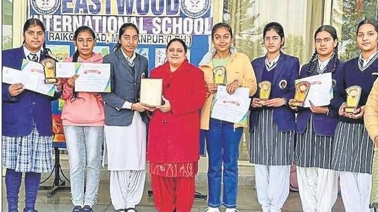 Students of Eastwood International showcasing their trophies and certificates. Students of Eastwood International showcasing their trophies and certificates.
