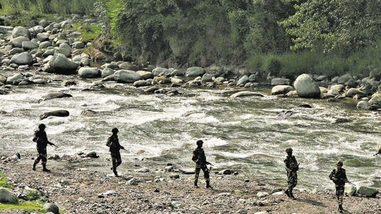 BSF soldiers patrol next to a stream near the Line of Control in Poonch district. (Reuters File Photo )