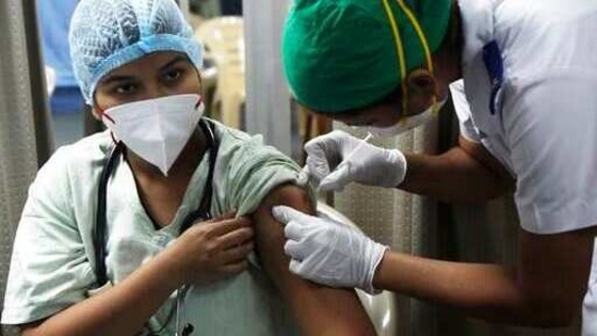 A health worker administers COVID-19 vaccine to another at the Sion Municipal Hospital in Mumbai, India, Tuesday, Feb. 2, 2021. (AP Photo/Rajanish Kakade) (AP) A health worker administers COVID-19 vaccine to another at the Sion Municipal Hospital in Mumbai, India, Tuesday, Feb. 2, 2021. (AP Photo/Rajanish Kakade) (AP)