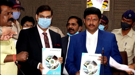 TMC chief Dr. Vipin Sharma (left) and standing committee chairman Sanjay Bhoir before presenting the 2021-22 budget in Thane on Friday. (Praful Gangurde/HT)