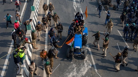 In this Tuesday, Jan.26, 2021, file photo, Indian policemen beat farmers driving a tractor towards the heart of the city as a sign of protest against new farm laws, during India's Republic Day celebrations in New Delhi, India. (AP) In this Tuesday, Jan.26, 2021, file photo, Indian policemen beat farmers driving a tractor towards the heart of the city as a sign of protest against new farm laws, during India's Republic Day celebrations in New Delhi, India. (AP)
