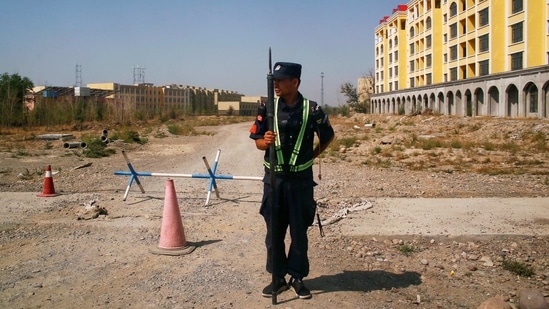 A Chinese police officer takes his position by the road near what is officially called a vocational education center in Yining in Xinjiang Uighur Autonomous Region, China. (File Photo) (REUTERS)