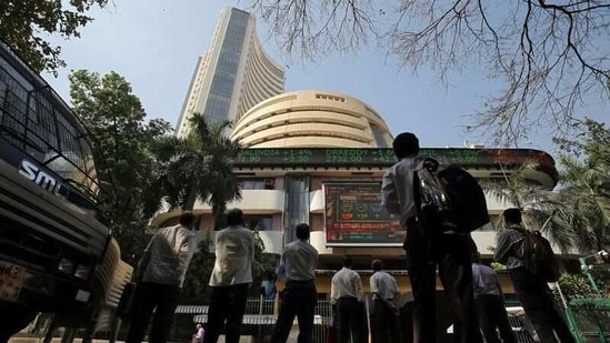 People look at a screen displaying the Sensex results on the facade of the Bombay Stock Exchange (BSE) building in Mumbai, India. (REUTERS)