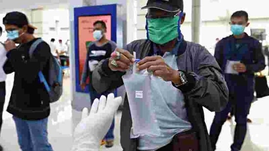 A man wearing a protective mask gives a plastic bag containing his air-sample to be tested using GeNose C19 (GeNose), a coronavirus disease (COVID-19) detection tool, at a train station in Jakarta, Indonesia, February 3, 2021. REUTERS/Ajeng Dinar Ulfiana (REUTERS)