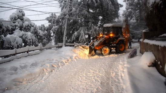 An excavator clears snow from Sanjauli-IGMC road in Shimla, Himachal Pradesh on February 4. “Continuous snowfall has hampered efforts to clear snow accumulated on roads in Shimla and surrounding areas,” Shimla additional superintendent of police Parveer Thakur told HT.(Deepak Sansta / HT Photo)