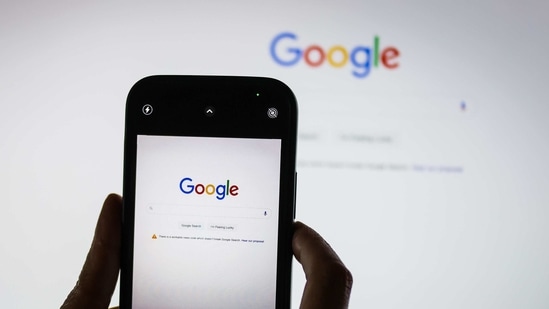 The Google logo on the company's homepage, arranged on an iPhone and a desktop computer in Sydney, Australia.(Bloomberg)