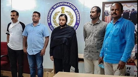 Kerala gold smuggling case accused Swapna Suresh and Sandeep Nair (middle) after they were arrested by the NIA in on July 11, 2020. (File photo) Kerala gold smuggling case accused Swapna Suresh and Sandeep Nair (middle) after they were arrested by the NIA in on July 11, 2020. (File photo)