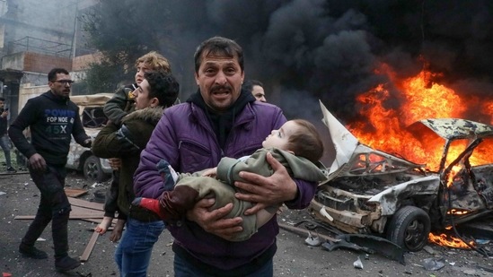 Civilians carry a young victim at the scene of an explosion in the rebel-controlled northern countryside of Syria's Aleppo province.(AFP) Civilians carry a young victim at the scene of an explosion in the rebel-controlled northern countryside of Syria's Aleppo province.(AFP)