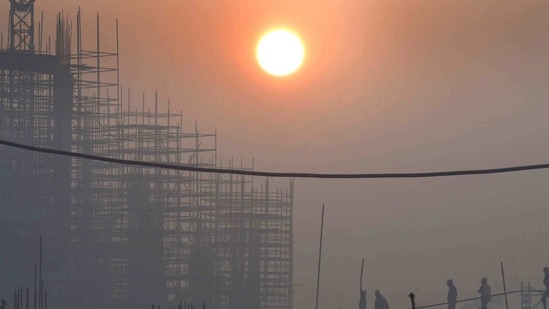 The rising sun seen over a construction site on a foggy morning at Pragati Maidan, New Delhi. (Arvind Yadav/ Hindustan Times) The rising sun seen over a construction site on a foggy morning at Pragati Maidan, New Delhi. (Arvind Yadav/ Hindustan Times)