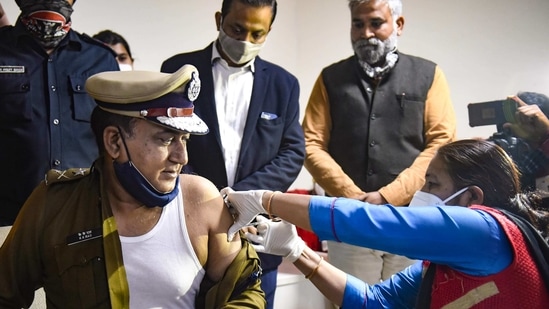 A medic administers Covishield vaccine dose Police Commissioner KK Rao in the presence of Haryana Home Minister Anil Vij on February 4. (PTI) A medic administers Covishield vaccine dose Police Commissioner KK Rao in the presence of Haryana Home Minister Anil Vij on February 4. (PTI)