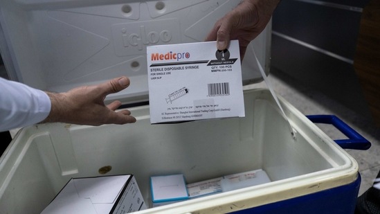 Medics unpack Moderna COVID-19 vaccines and supplies that are designated for front-line medical workers. (AP) Medics unpack Moderna COVID-19 vaccines and supplies that are designated for front-line medical workers. (AP)