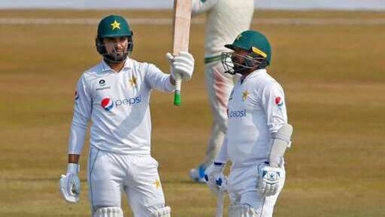 Pakistan's Faheem Ashraf, left, raises bat(AP) Pakistan's Faheem Ashraf, left, raises bat(AP)