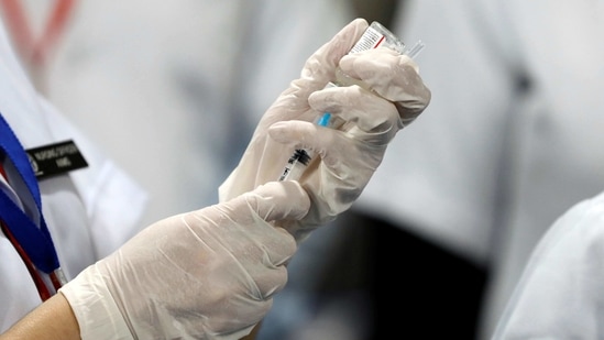 A healthcare worker fills a syringe with a dose of Bharat Biotech's COVID-19 vaccine called COVAXIN, during the coronavirus disease (COVID-19) vaccination campaign at All India Institute of Medical Sciences (AIIMS) hospital in New Delhi, India, January 16, 2021. REUTERS/Adnan Abidi(REUTERS)