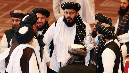 Taliban delegates speak during talks between the Afghan government and Taliban insurgents in Doha, Qatar.(REUTERS)