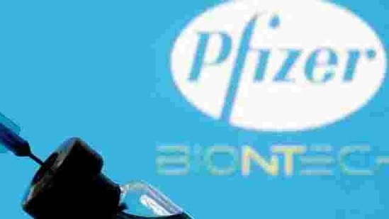 A vial and syringe are seen in front of a displayed Pfizer and Biontech logo in this illustration taken January 11, 2021. (REUTERS)
