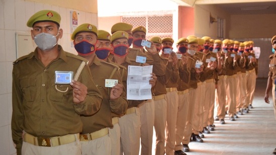 Police personnel stand in a queue to receive their first dose of Covishield vaccine, during an inoculation drive against Covid-19 in Mirzapur. (PTI) Police personnel stand in a queue to receive their first dose of Covishield vaccine, during an inoculation drive against Covid-19 in Mirzapur. (PTI)