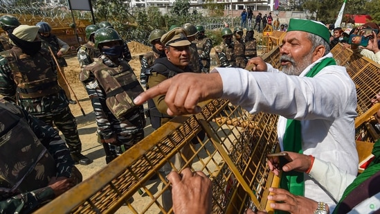 BKU leader Rakesh Tikait gestures towards security personnel who had blocked farmers' movement during their protest against Centre's farm laws, at Ghazipur border in New Delhi, Saturday, Feb. 6, 2021.(PTI ) BKU leader Rakesh Tikait gestures towards security personnel who had blocked farmers' movement during their protest against Centre's farm laws, at Ghazipur border in New Delhi, Saturday, Feb. 6, 2021.(PTI )