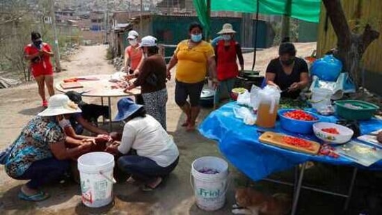 Residents prep donated vegetables at a soup kitchen in the Villa Maria shantytown of Lima, Peru, Tuesday, Feb. 2, 2021, amid a second complete lockdown in less than a year.(AP Photo) Residents prep donated vegetables at a soup kitchen in the Villa Maria shantytown of Lima, Peru, Tuesday, Feb. 2, 2021, amid a second complete lockdown in less than a year.(AP Photo)