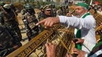 New Delhi: BKU leader Rakesh Tikait gestures towards security personnel who had blocked farmers' movement during their protest against Centre's farm laws, at Ghazipur border in New Delhi on Saturday. (PTI Photo ) New Delhi: BKU leader Rakesh Tikait gestures towards security personnel who had blocked farmers' movement during their protest against Centre's farm laws, at Ghazipur border in New Delhi on Saturday. (PTI Photo )