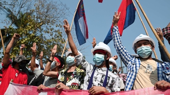 Demonstrators show the three-finger salute to protest against the military coup and demand the release of elected leader Aung San Suu Kyi, in Yangon, Myanmar, February 6, 2021.(REUTERS)