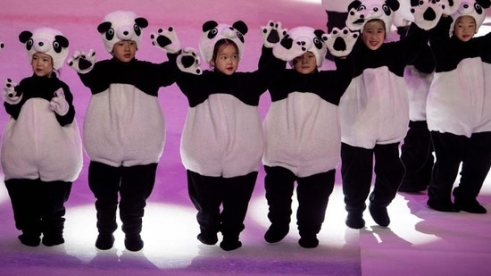 Children wearing panda costumes dance during the official reveal of the mascots for the Beijing 2022 Winter Olympic and Paralympic Games at Shougang Ice Hockey Arena on September 17, 2019. (AFP file) Children wearing panda costumes dance during the official reveal of the mascots for the Beijing 2022 Winter Olympic and Paralympic Games at Shougang Ice Hockey Arena on September 17, 2019. (AFP file)