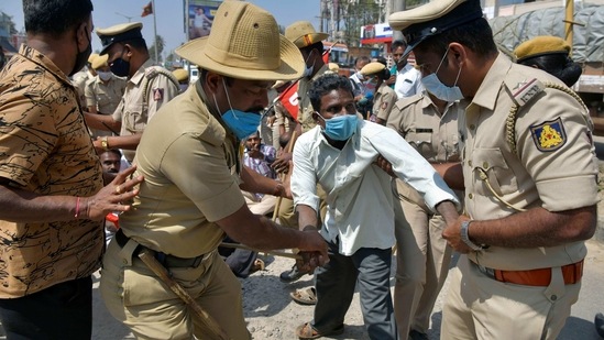 Police detaining a protesting farmer belonging to the Karnataka Rajya Raitha Sangha (KRRS) during a demonstration in Tumkur district, Karnataka on February 6. The government and farm unions have not been able to find a solution to the stand-off over 11 rounds of talks, and the farmers have rejected a proposal by the Centre to put the laws on hold for 18 months.(Manjunath Kiran / AFP)