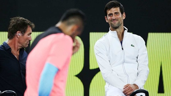 Novak Djokovic of Serbia looks at Nick Kyrgios of Australia. (Getty Images)