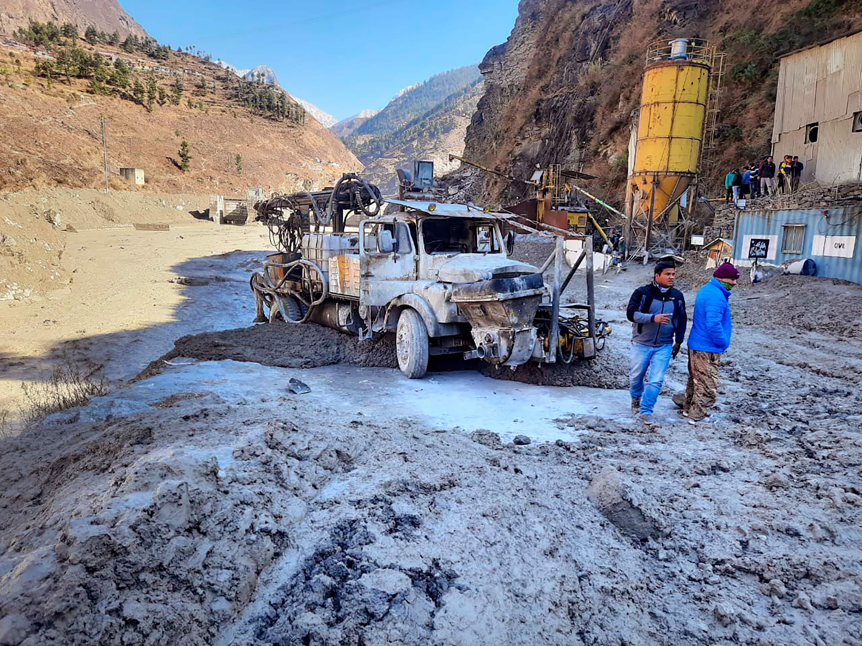 People inspect the site near the damaged Dhauliganga hydropower project at Reni village in Chamoli district after a portion of Nanda Devi glacier broke off in Tapovan area of the northern state of Uttarakhand. (AP Photo) People inspect the site near the damaged Dhauliganga hydropower project at Reni village in Chamoli district after a portion of Nanda Devi glacier broke off in Tapovan area of the northern state of Uttarakhand. (AP Photo)