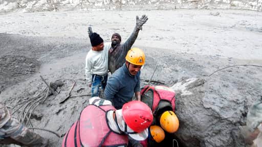 This photograph provided by Indo Tibetan Border Police (ITBP) shows a man reacting after he was pulled out from beneath the ground by ITBP personnel during rescue operations after a portion of Nanda Devi glacier broke off in Tapovan area of the northern state of Uttarakhand. (AP) This photograph provided by Indo Tibetan Border Police (ITBP) shows a man reacting after he was pulled out from beneath the ground by ITBP personnel during rescue operations after a portion of Nanda Devi glacier broke off in Tapovan area of the northern state of Uttarakhand. (AP)