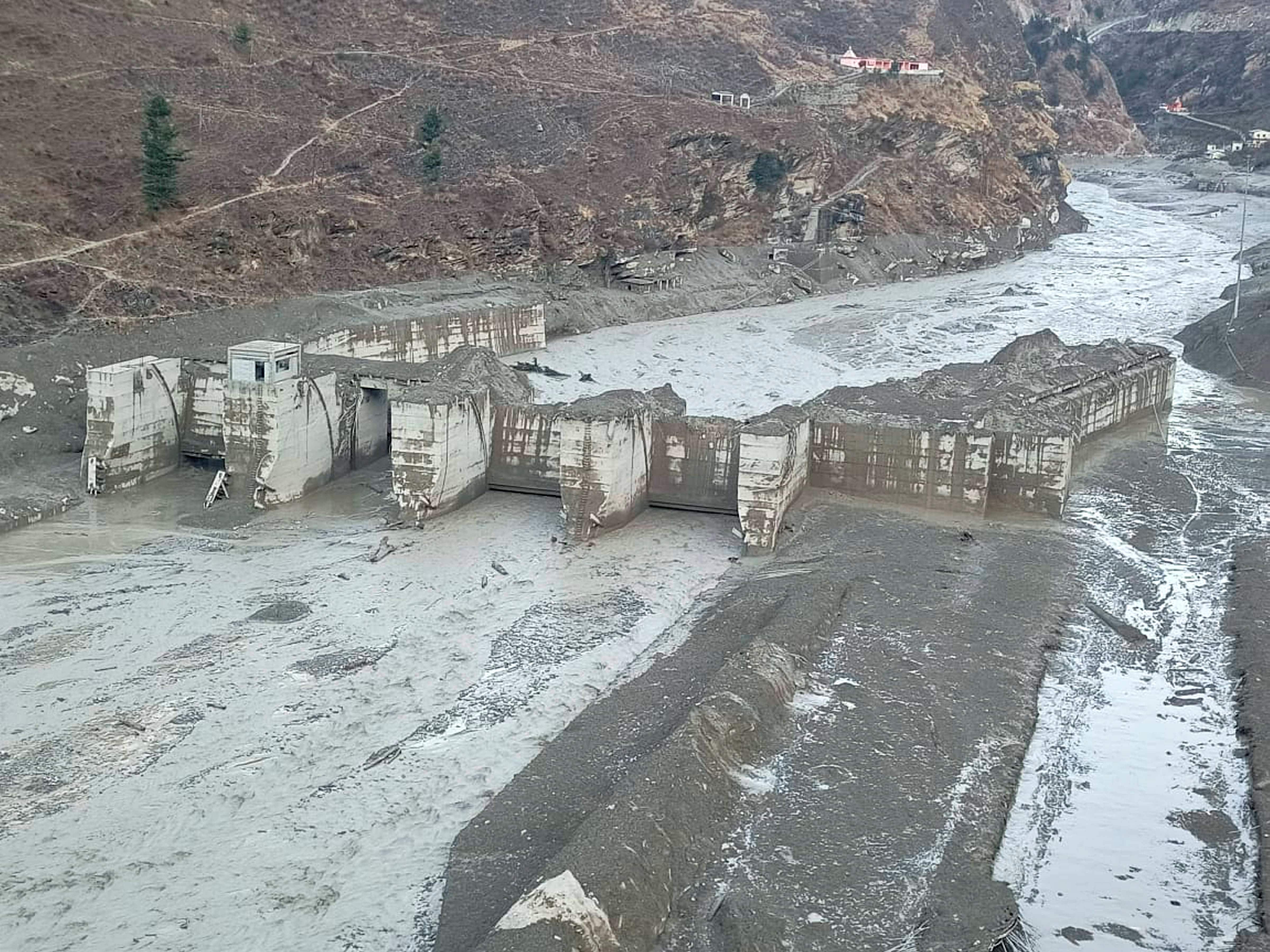 Damaged Dhauliganga hydropower project after a glacier broke off in Joshimath causing a massive flood in the Dhauli Ganga river, in Chamoli district of Uttarakhand. (PTI Photo) Damaged Dhauliganga hydropower project after a glacier broke off in Joshimath causing a massive flood in the Dhauli Ganga river, in Chamoli district of Uttarakhand. (PTI Photo)