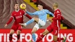 Liverpool: Manchester City's Phil Foden controls the ball between Liverpool's Jordan Henderson, left, and Liverpool's Fabinho during the English Premier League soccer match between Liverpool and Manchester City at Anfield Stadium, Liverpool.(AP) Liverpool: Manchester City's Phil Foden controls the ball between Liverpool's Jordan Henderson, left, and Liverpool's Fabinho during the English Premier League soccer match between Liverpool and Manchester City at Anfield Stadium, Liverpool.(AP)