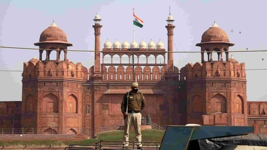 A police personnel stands guard in front of Red Fort during a roadblock-protest by farmers against the new farm laws, at Red Fort in New Delhi on Saturday. (ANI Photo) A police personnel stands guard in front of Red Fort during a roadblock-protest by farmers against the new farm laws, at Red Fort in New Delhi on Saturday. (ANI Photo)