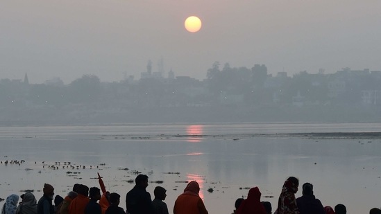 Devotees perform evening prayers on the banks of Sangam, the confluence of rivers Ganga, Yamuna and mythical Saraswati during the annual Hindu religious fair of Magh Mela in Allahabad. (AP)