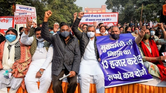 New Delhi: Delhi BJP President Adesh Gupta with Leader of Opposition in Delhi Assembly Ramvir Singh Bidhuri and party councillors stages a 'Satyagrah' protest demanding the release of the due fund of corporations, near APP office in New Delhi, Tuesday, Dec. 22, 2020. (PTI Photo/Kamal Singh) (PTI22-12-2020_000151B) (PTI) New Delhi: Delhi BJP President Adesh Gupta with Leader of Opposition in Delhi Assembly Ramvir Singh Bidhuri and party councillors stages a 'Satyagrah' protest demanding the release of the due fund of corporations, near APP office in New Delhi, Tuesday, Dec. 22, 2020. (PTI Photo/Kamal Singh) (PTI22-12-2020_000151B) (PTI)