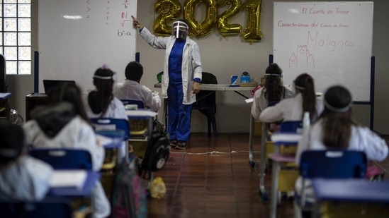 A math teacher stands before students, all wearing Covid-19 protective gear in Chia on the outskirts of Bogota, Colombia. (AP File Photo ) A math teacher stands before students, all wearing Covid-19 protective gear in Chia on the outskirts of Bogota, Colombia. (AP File Photo )