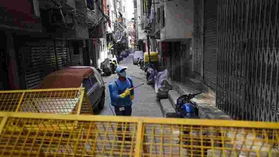 An MCD worker sprays disinfectant while sanitizing the West Vinod Nagar area.(Ajay Aggarwal / HT Photo) An MCD worker sprays disinfectant while sanitizing the West Vinod Nagar area.(Ajay Aggarwal / HT Photo)