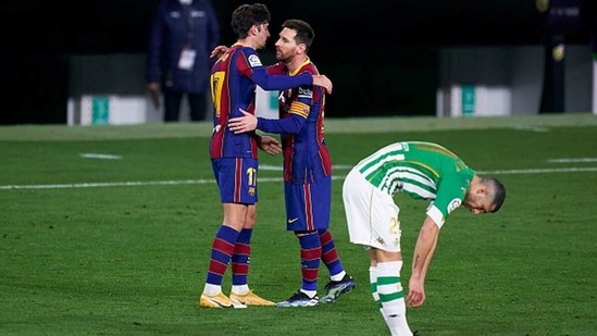 Lionel Messi of FC Barcelona celebrates with his teammate Francisco Trincao. (Getty Images)