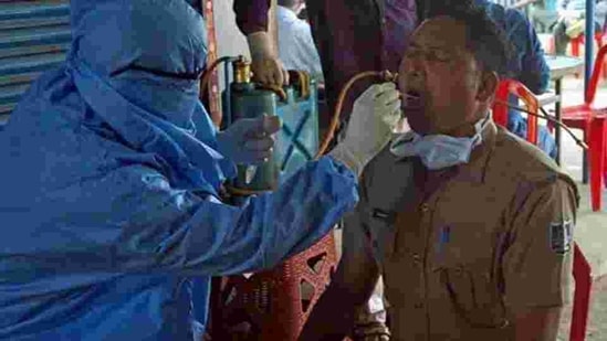 A health worker collects swab samples of a policeman for Covid-19 test in Bhubaneswar. (ANI FILE) A health worker collects swab samples of a policeman for Covid-19 test in Bhubaneswar. (ANI FILE)