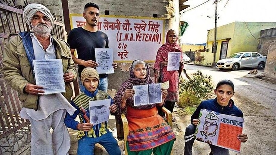 The family of INA veteran Sube Singh shows documents relating to his service at the INA outside their house in village Tikri Kalan, in New Delhi, India, on Sunday, February 7, 2021. (Photo by Raj K Raj/ Hindustan Times) 