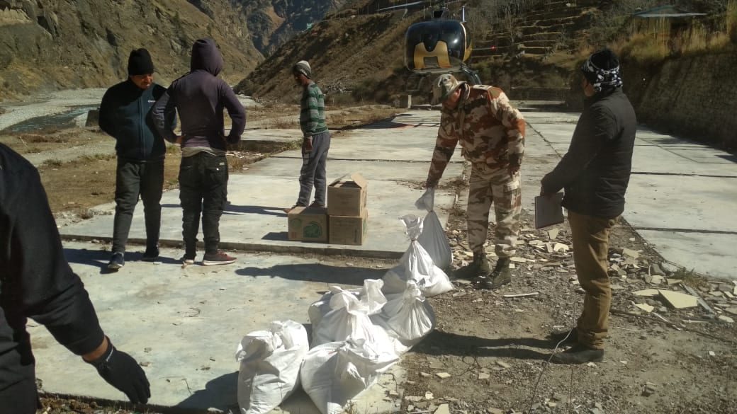 Visuals from Lata Helipad where ITBP personnel are seen with ration packets. (HT Photo)