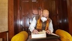 Home Minister Amit Shah signs the visitor's book during his visit to Rabindra Bhawan, at Shantiniketan. (PTI Photo) Home Minister Amit Shah signs the visitor's book during his visit to Rabindra Bhawan, at Shantiniketan. (PTI Photo)