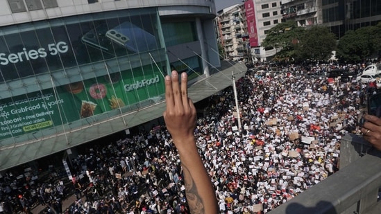 Protesters take part in a demonstration against the military coup in Yangon on February 9. Police fired gunshots into the air and used water cannon and rubber bullets on February 9 as protesters across Myanmar defied bans on big gatherings to oppose a military coup that halted a tentative transition to democracy.( Sai Aung Main / AFP)