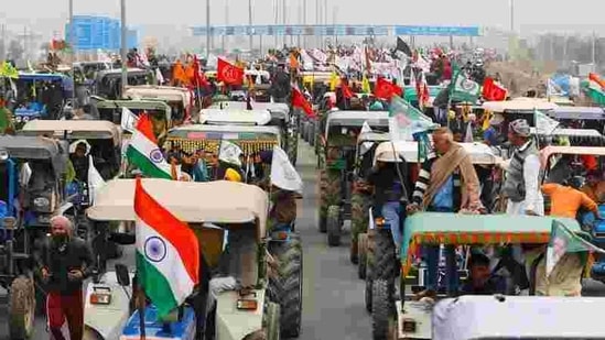 Farmers participate in a tractor rally to protest against the newly passed farm bills, on a highway on the outskirts of New Delhi. (REUTERS)
