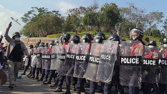 Protesters and police are seen in a rally against the military coup, in Naypyitaw on February 8. Witnesses told Reuters that police fired guns into the air in Naypyitaw as a crowd refused to disperse on the fourth straight day of protests. One witness told Reuters that demonstrators ran away as guns were fired into the air.(REUTERS)